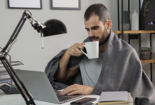 man having coffee while working from home 660x447 - A pandemia e o trabalho remoto. Ao que devemos nos atentar?